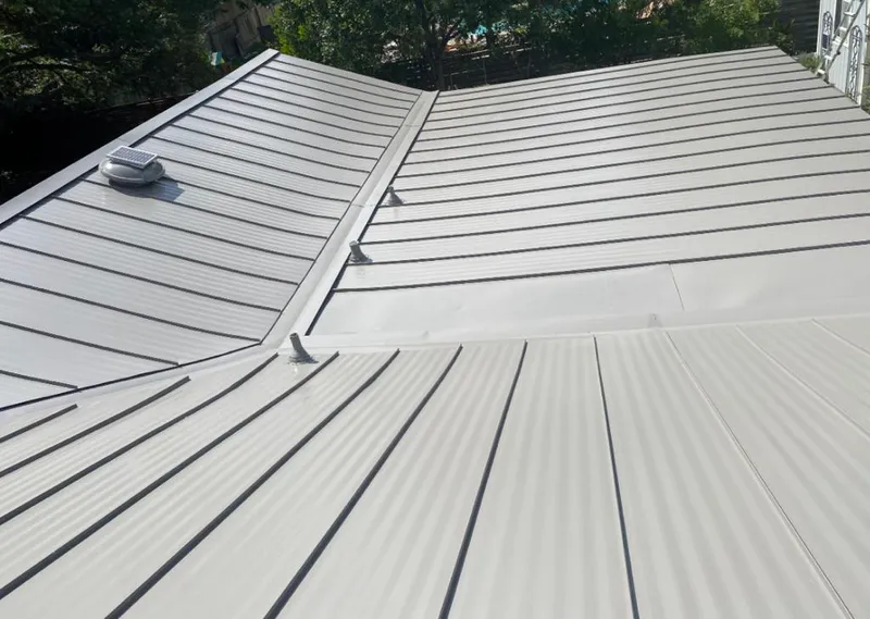 Solar attic fan installed on a metal roof for Roof Ventilation in Chapel Hill